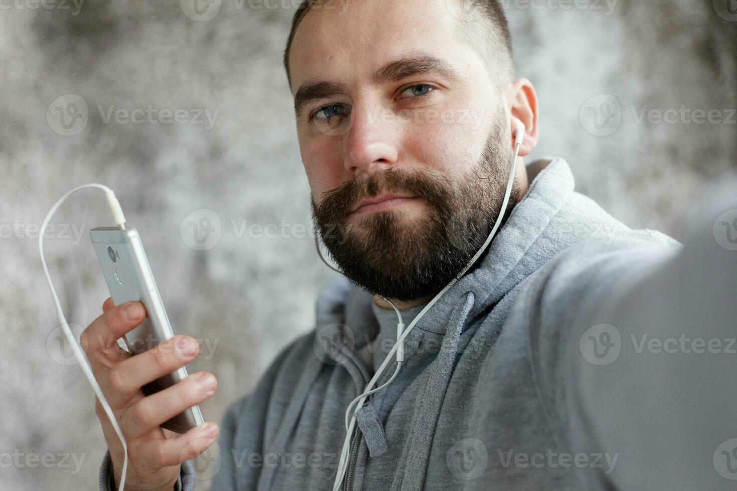 man in studio puts ear phones out to music. photo