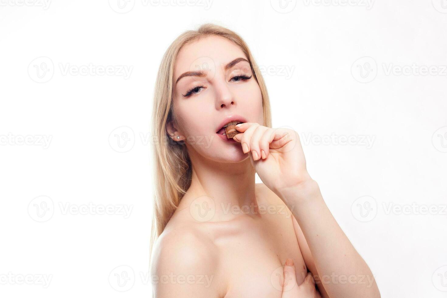 Lovely smiling teenage girl eating chocolate photo