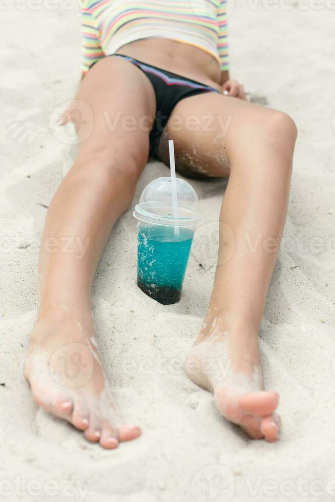 Beach woman drinking cold drink beverage having fun at beach party. photo