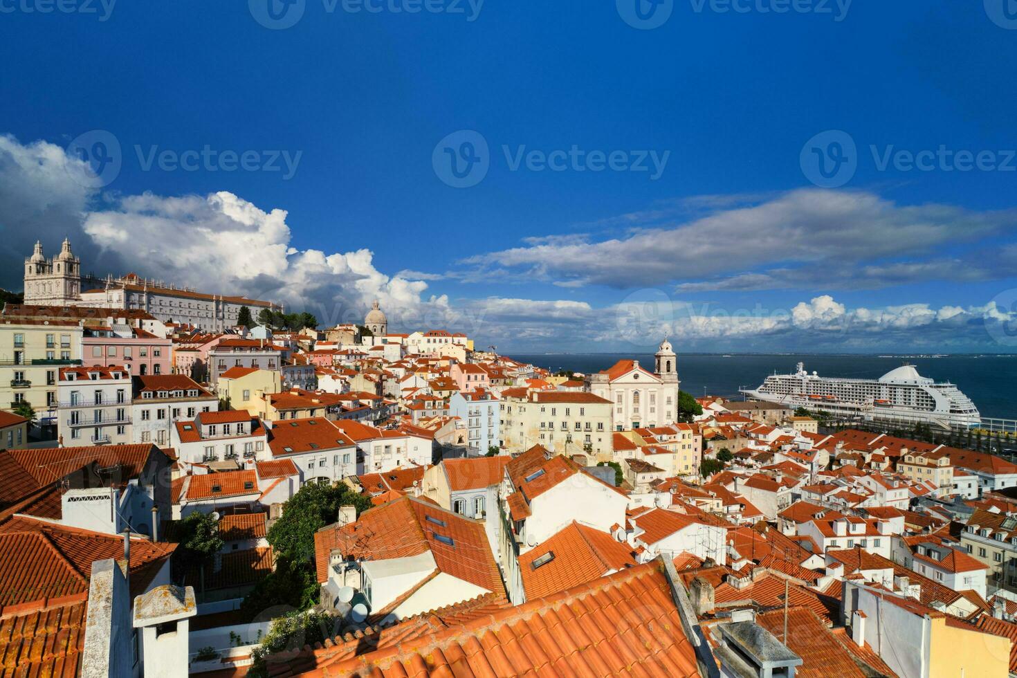 View of Lisbon from Miradouro de Santa Luzia viewpoint with moored cruise liner and moving clouds. Lisbon, Portugal photo