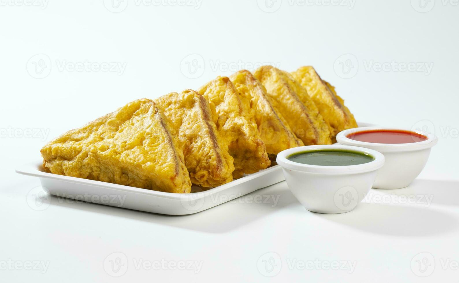 Indian Fried Snack Bread Pakora or Bread Bhaji Served with Tomato Ketchup, Green Chutney it is Made From Bread Slices photo