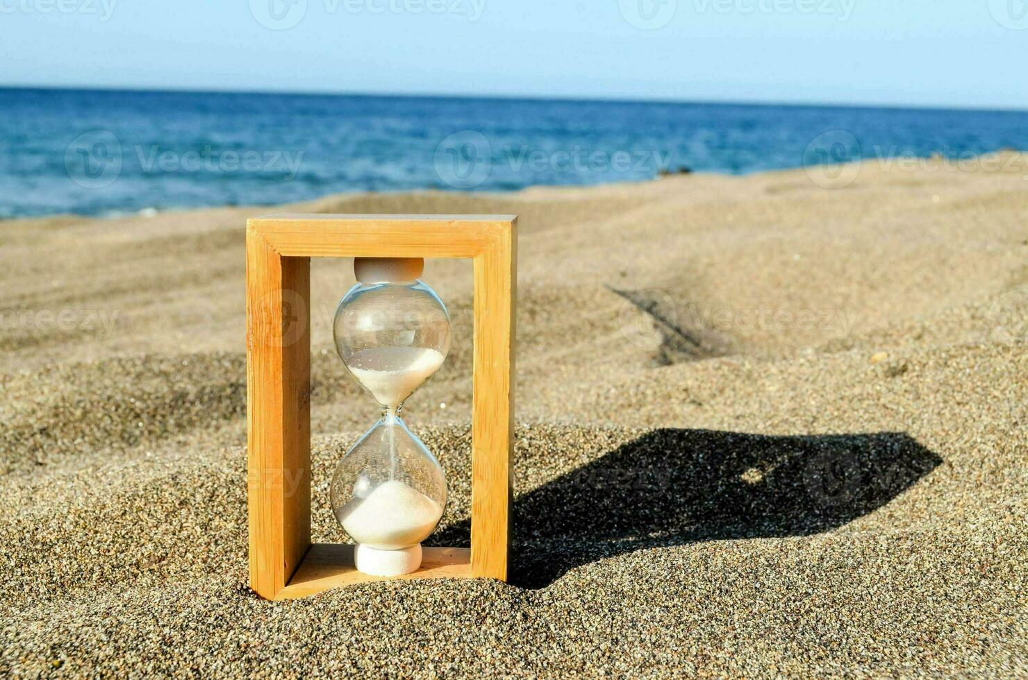 an hourglass on the beach with sand photo