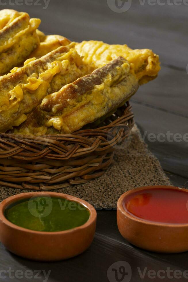 Indian Fried Snack Bread Pakora or Bread Bhaji Served with Tomato Ketchup, Green Chutney it is Made From Bread Slices photo