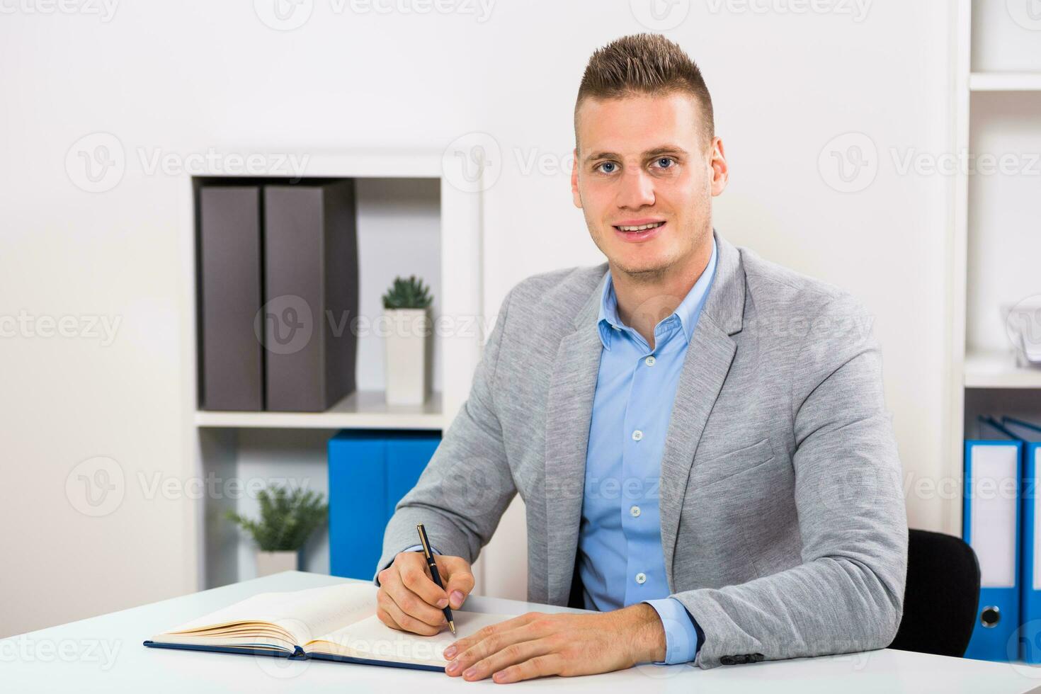 Businessman sitting in his office and working photo