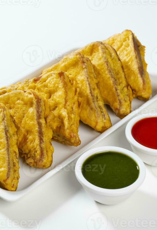 Indian Fried Snack Bread Pakora or Bread Bhaji Served with Tomato Ketchup, Green Chutney it is Made From Bread Slices photo