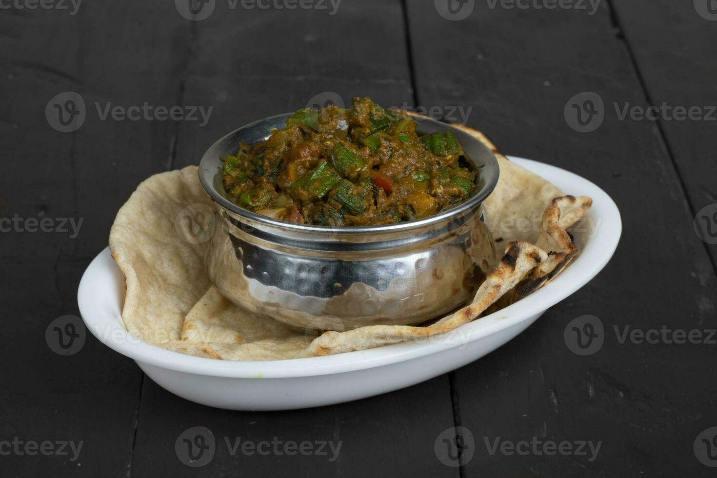 Indian Cuisine Bhindi Masala on Wooden Background photo