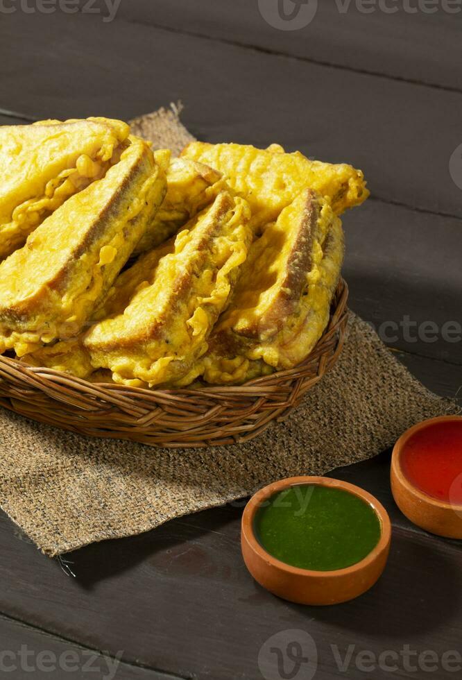 Indian Fried Snack Bread Pakora or Bread Bhaji Served with Tomato Ketchup, Green Chutney it is Made From Bread Slices photo