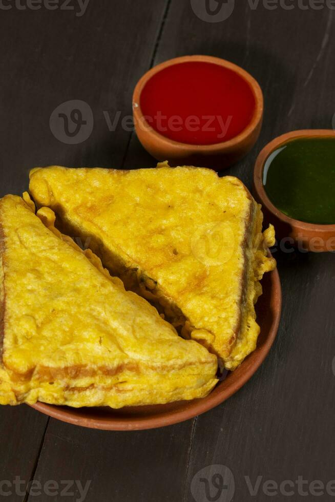 Indian Fried Snack Bread Pakora or Bread Bhaji Served with Tomato Ketchup, Green Chutney it is Made From Bread Slices photo