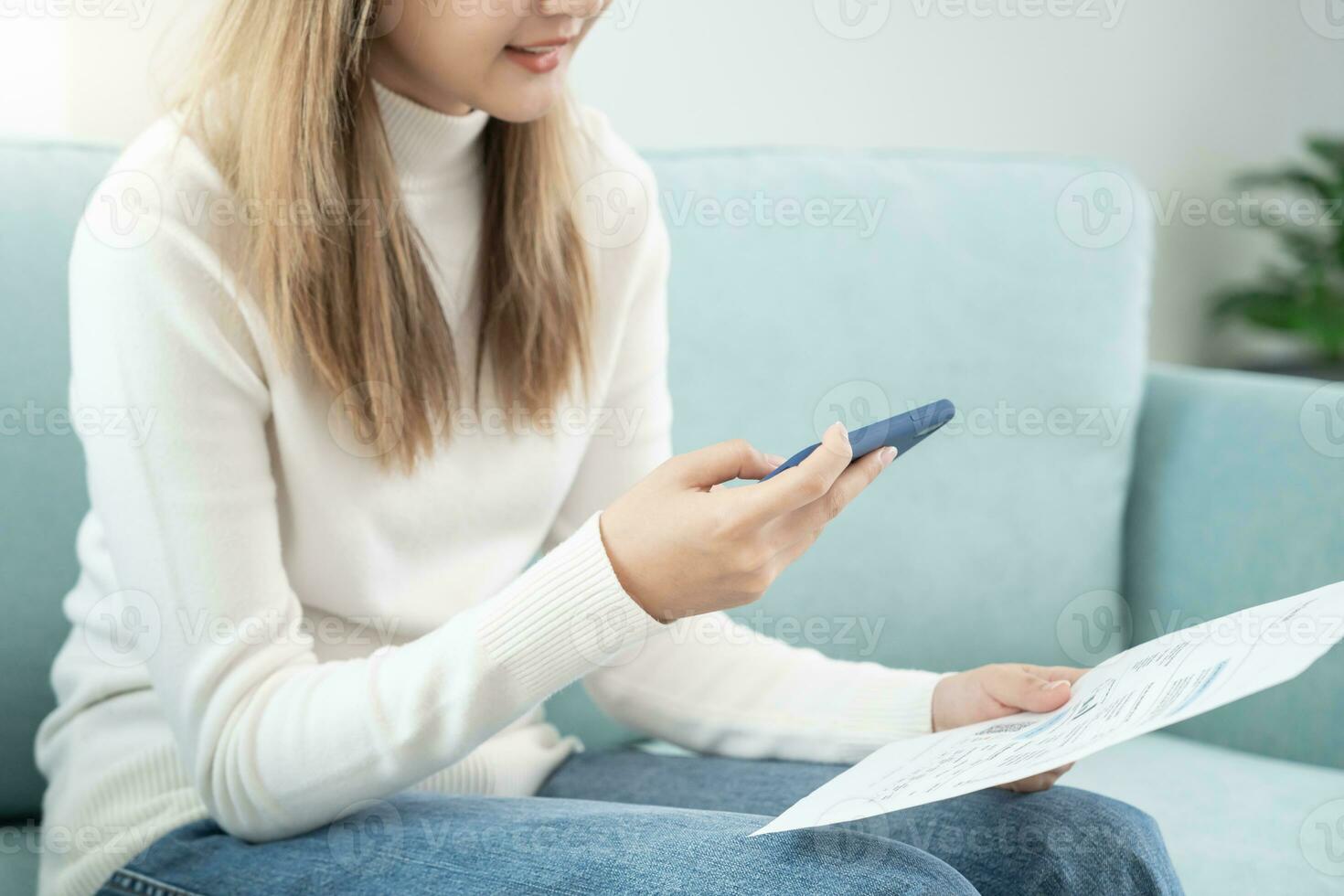 Modern woman use phone to scan barcode or QR codes to pay credit card bill after receive document invoice. payment, receive, paying electricity, digital payments without money, technology, scanning photo