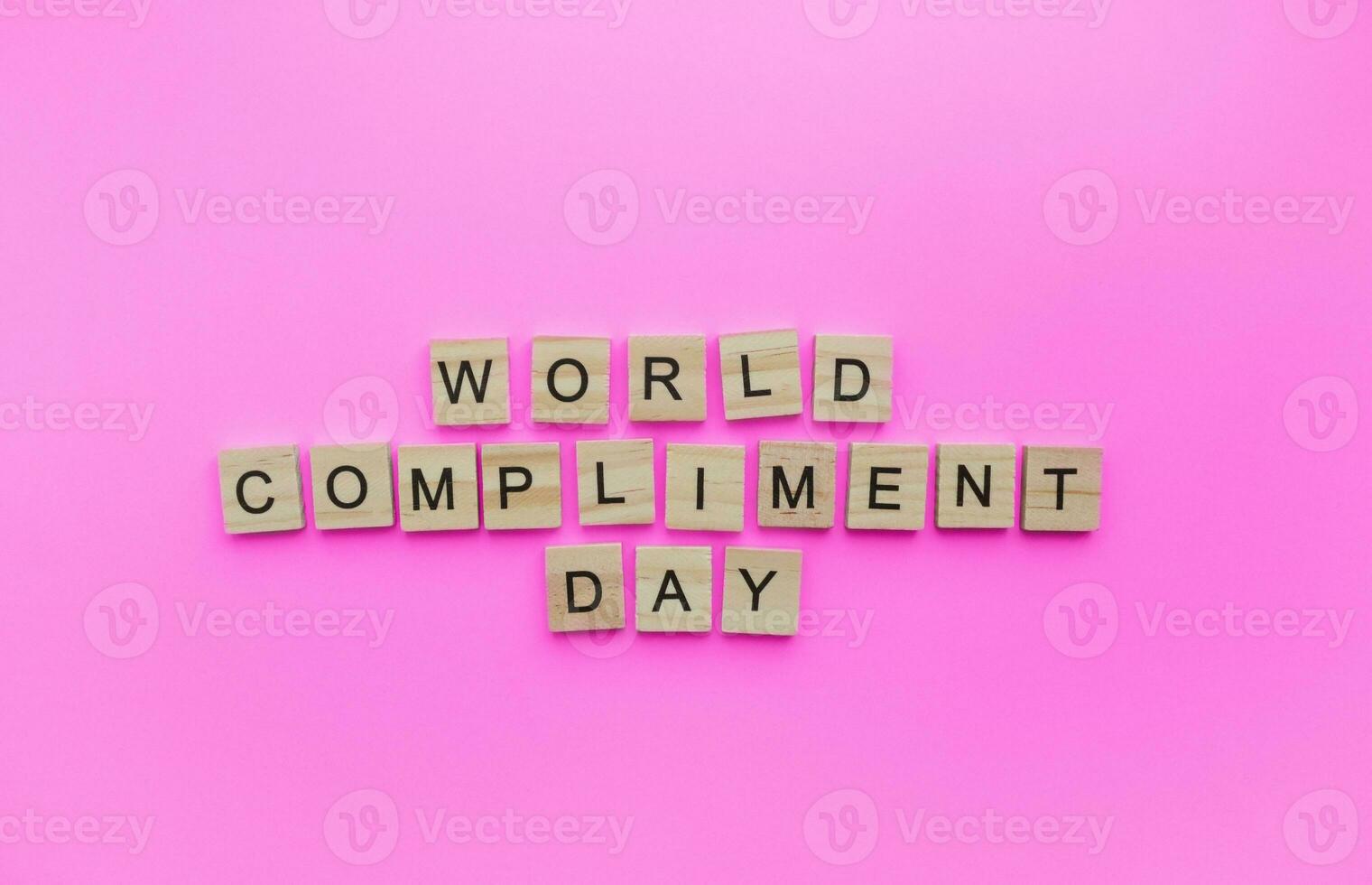 March 1, World compliment day, a minimalistic banner with an inscription in wooden letters photo