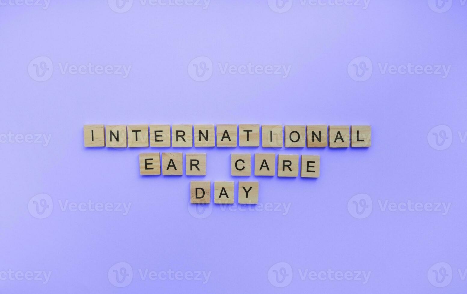 March 3, International Ear Care Day, International Day for War and Hearing, a minimalistic banner with an inscription in wooden letters photo