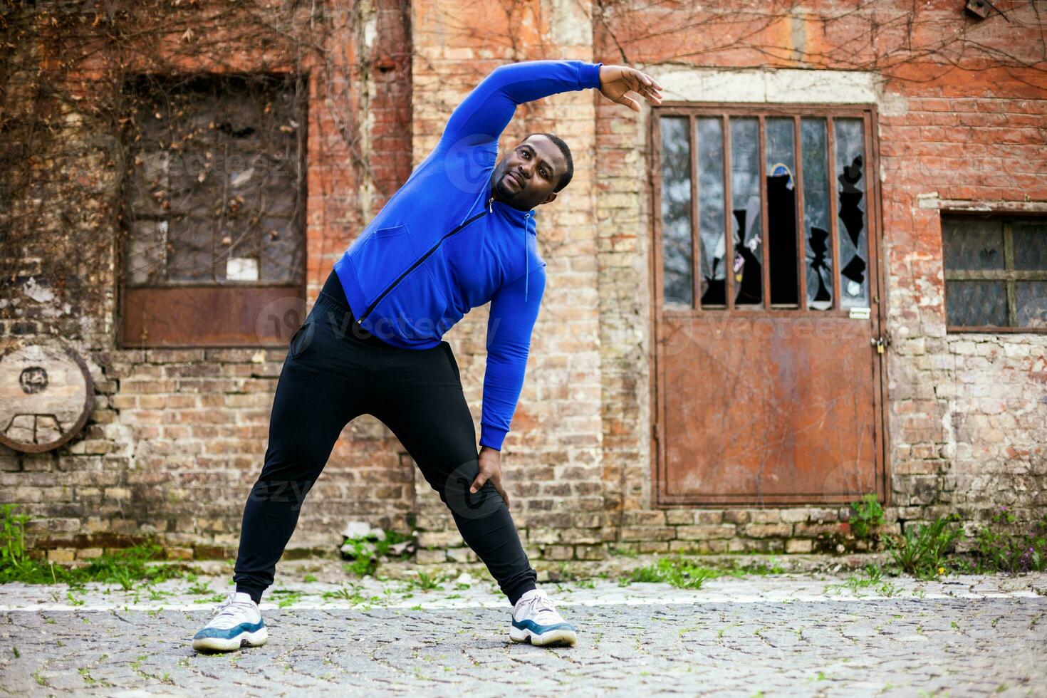 Sporty man enjoys  exercising outdoor. photo