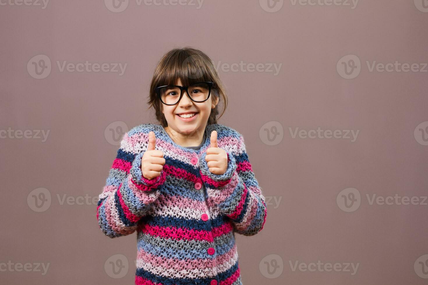 Little nerdy girl giving thumb up photo