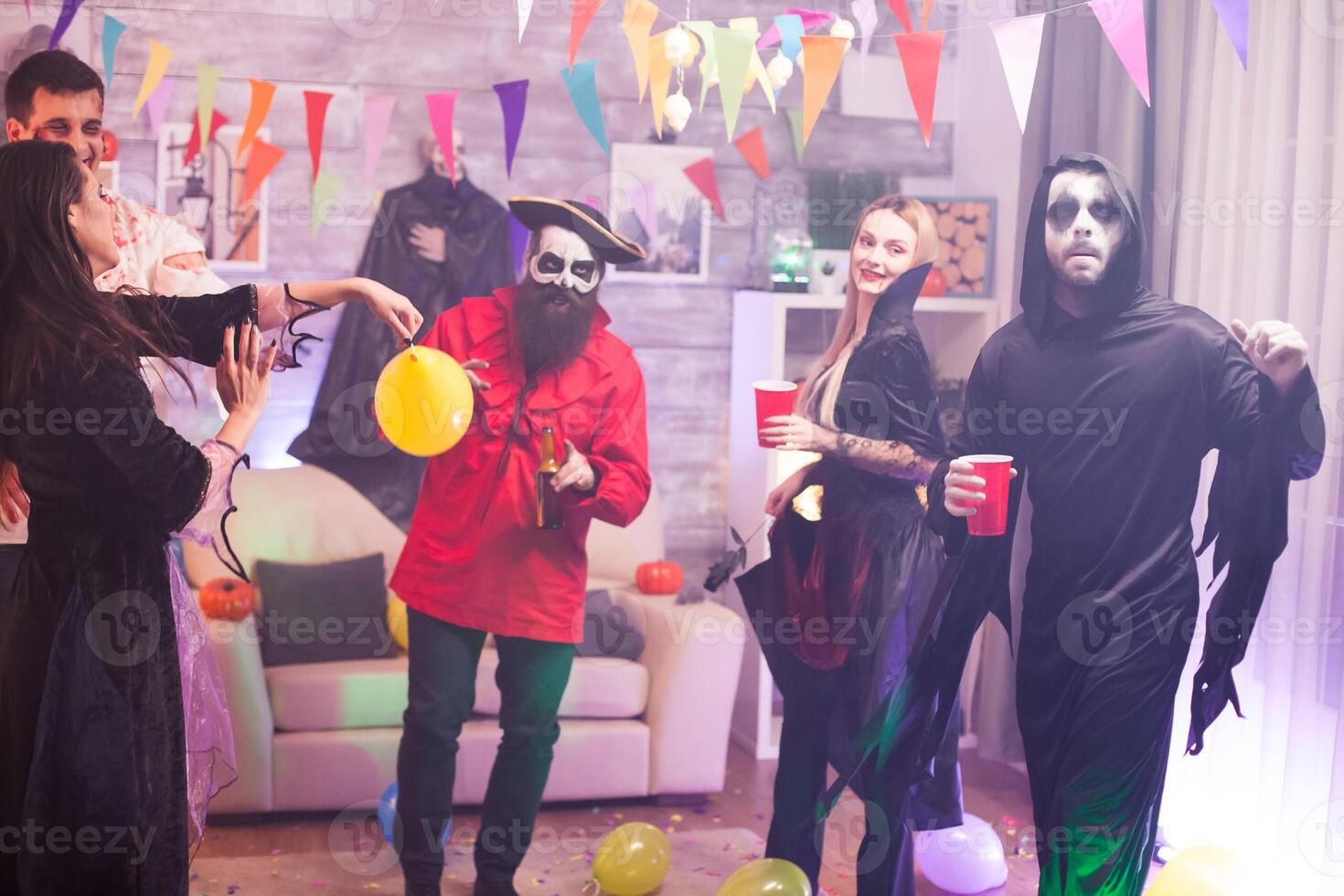 Monsters at a halloween celebration drinking alcohol. photo