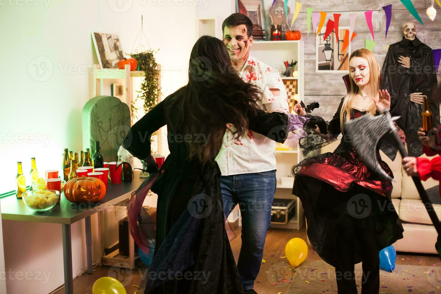 Back view of woman dressed up like a witch at halloween celebration. photo