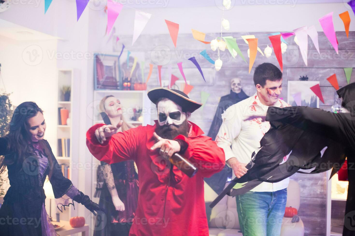 Man dressed up like pirate feeling good with his friends at halloween party. photo
