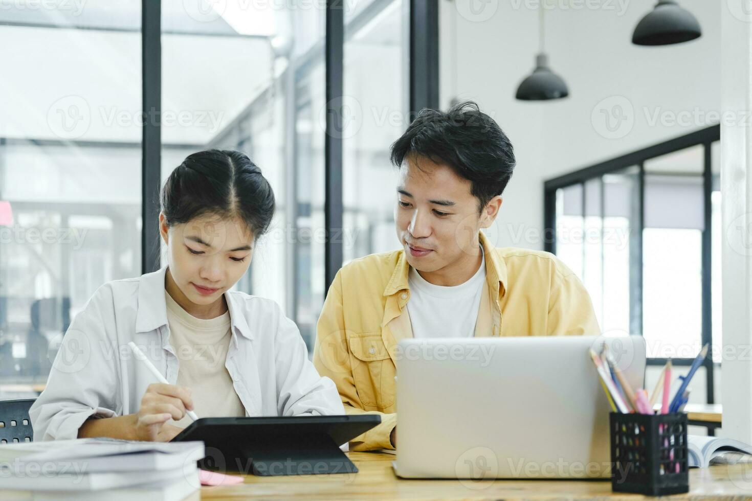 Young students campus helps friend catching up and learning. photo