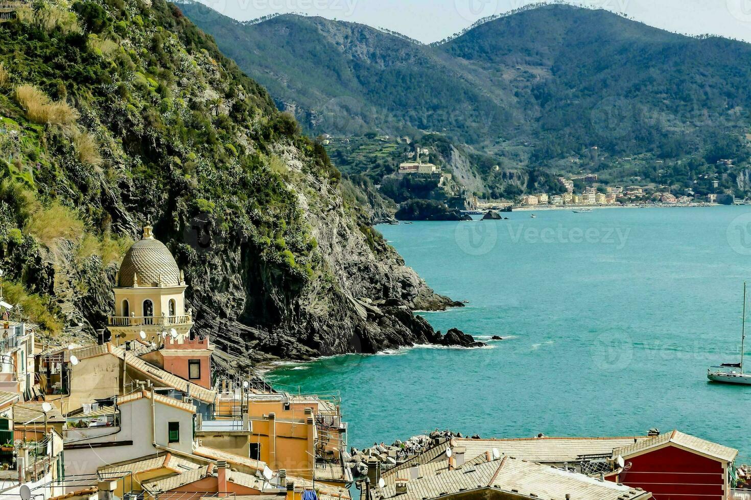 a view of the coast of italy with boats in the water photo