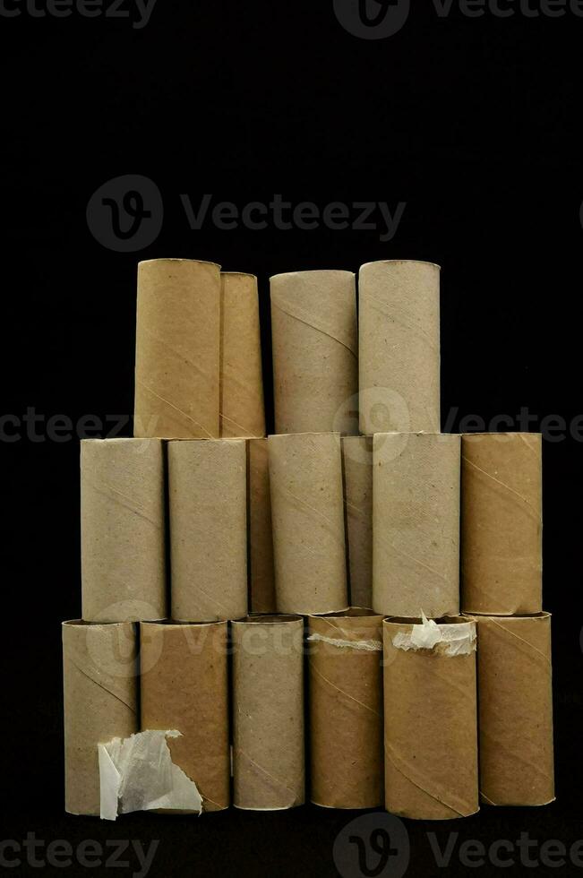 a pile of toilet paper rolls on a black background photo