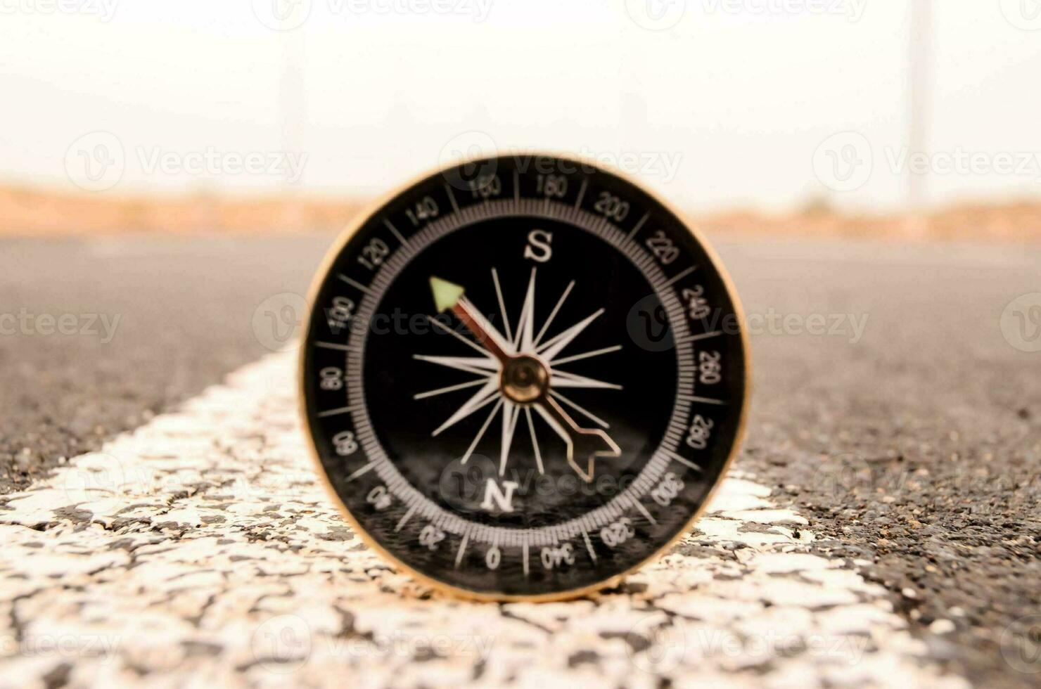 a compass is sitting on the road in the middle of the road photo