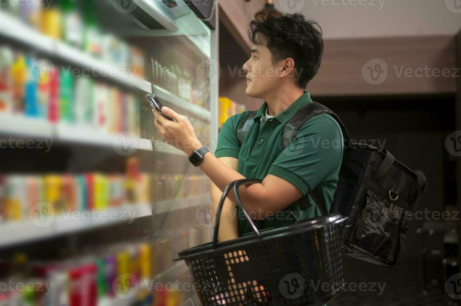 An Asian man delivery choosing goods from online order in supermarket , online delivery service concept photo