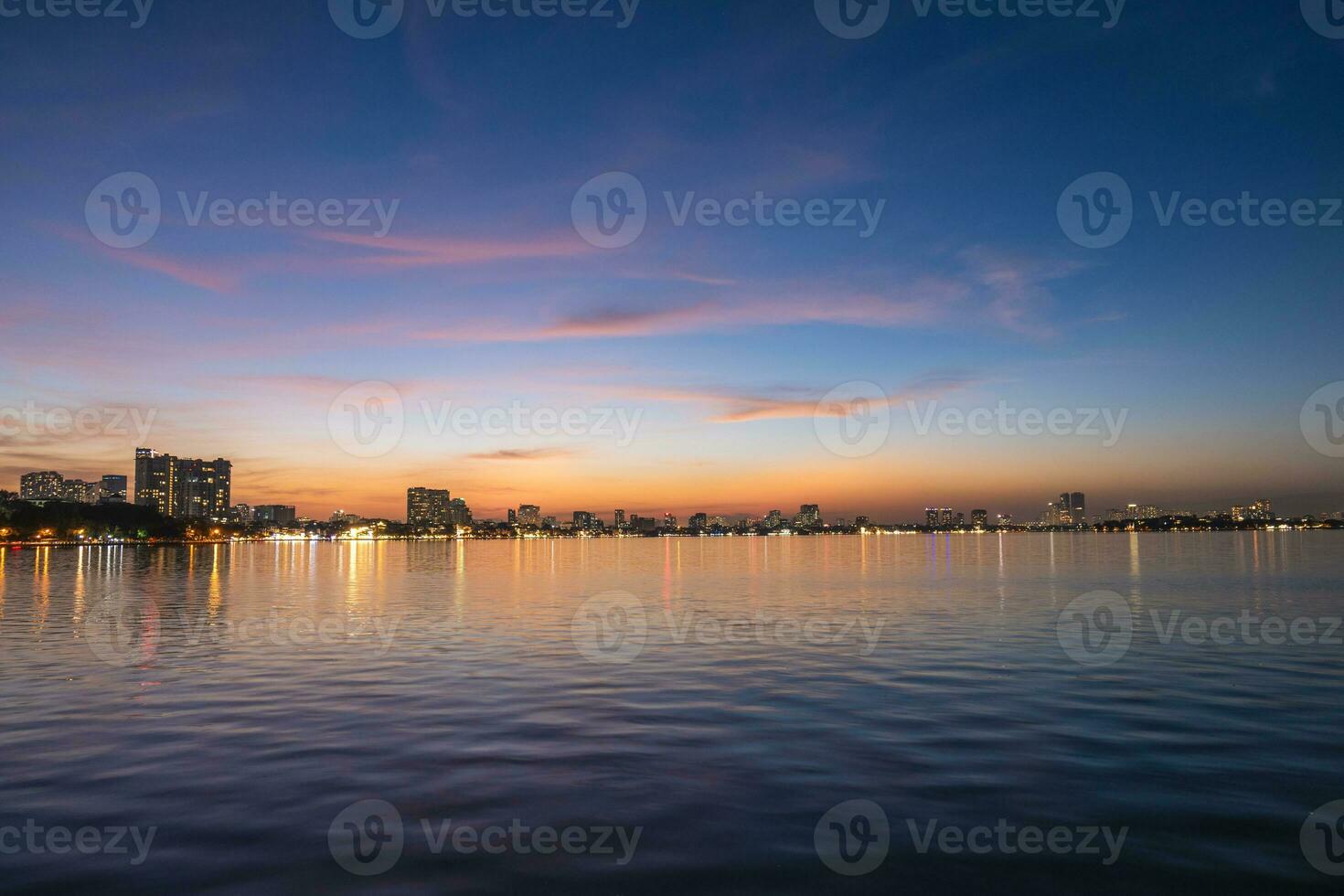 skyline of hanoi city by the west lake in Vietnam at night photo