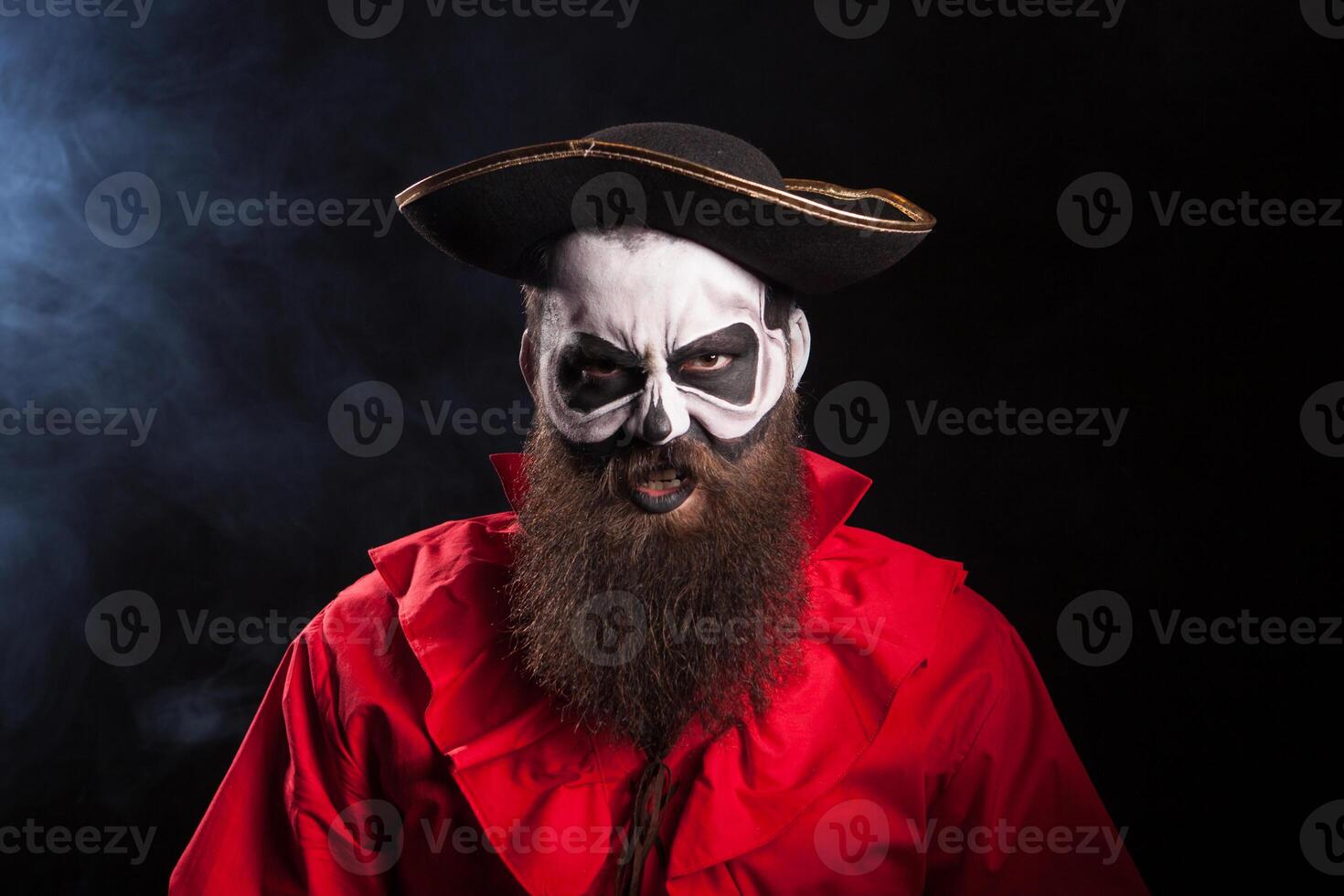 Crazy man dressed up like a pirate isolated on black background. Attractive captain. photo