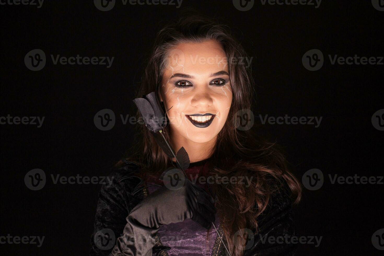 Attractive gothic woman dressed up like a witch for halloween. photo