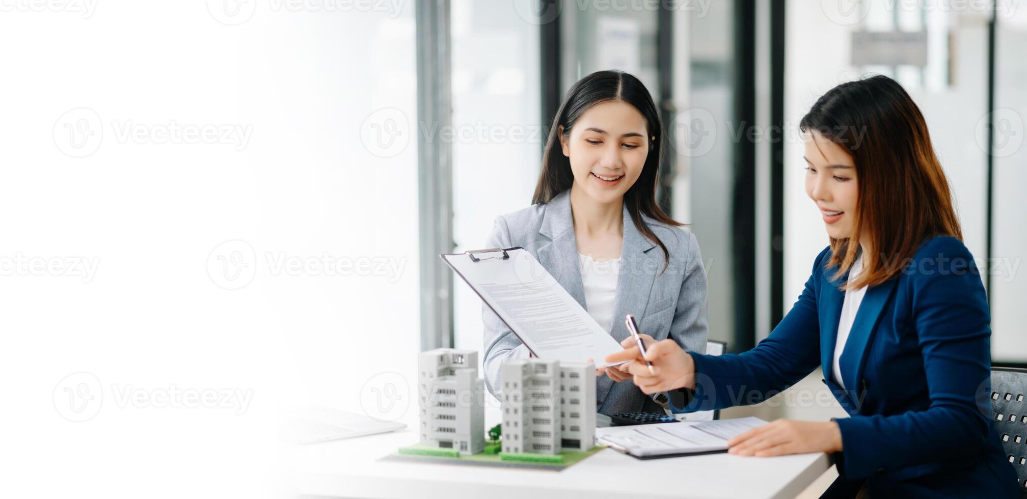 Signing a contract. Client and broker agent, lease agreement, successful deal and  Young business sitting in office photo