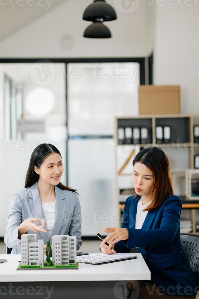 Signing a contract. Client and broker agent, lease agreement, successful deal and  Young business sitting in office photo