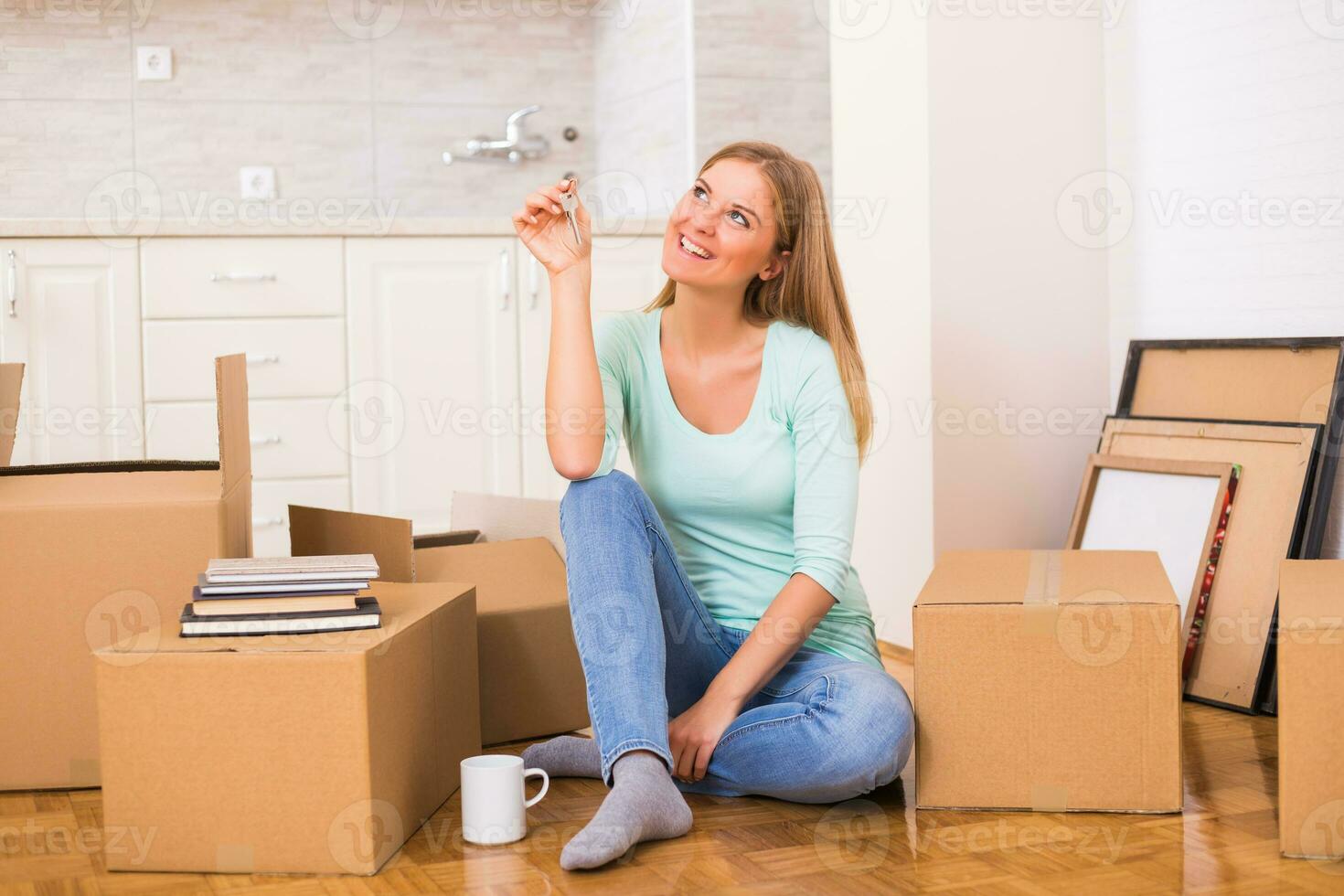 Beautiful woman holding key of her new home. photo