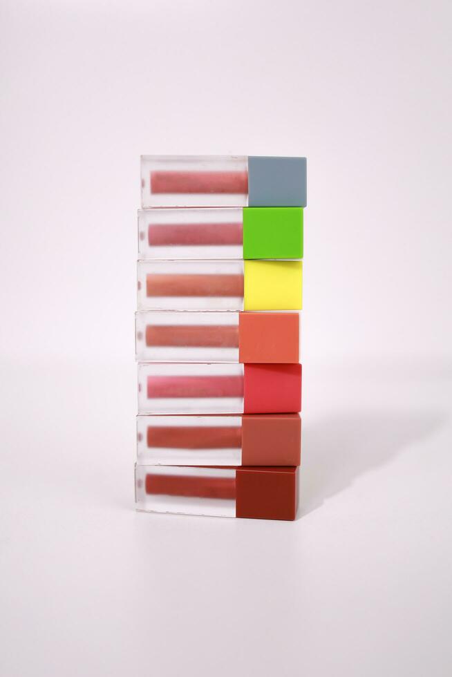 lip matte bottles randomly stacked on a white background isolated. Cosmetics for lips. Decorative cosmetics makeup women's lipstick beauty brand product design. photo