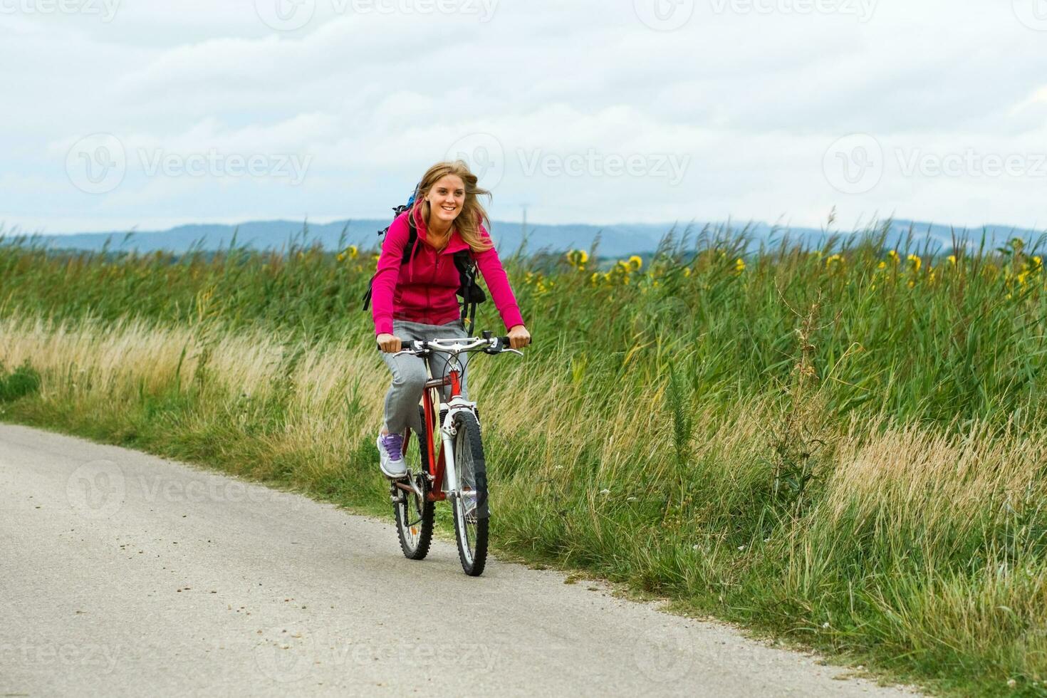 Woman hiker riding a bike. photo