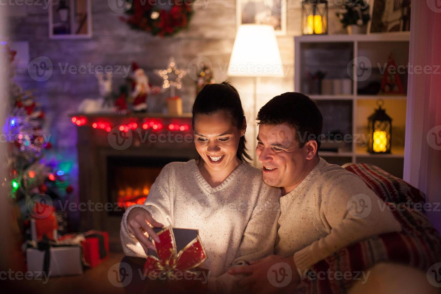 Caucasian woman happy about her christmas day from her husband. Glowing gift. photo