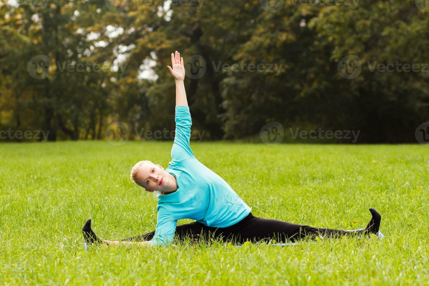 Woman doing yoga in nature photo
