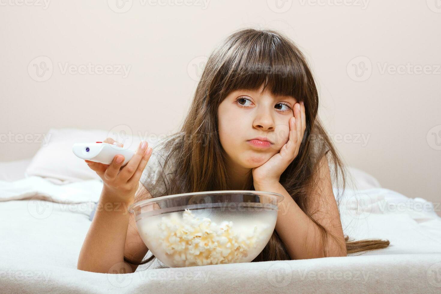 Little girl changing channels photo