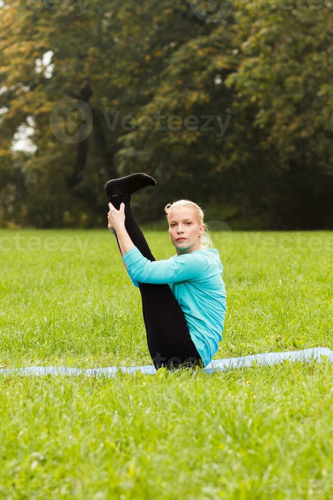 Woman doing yoga in nature photo