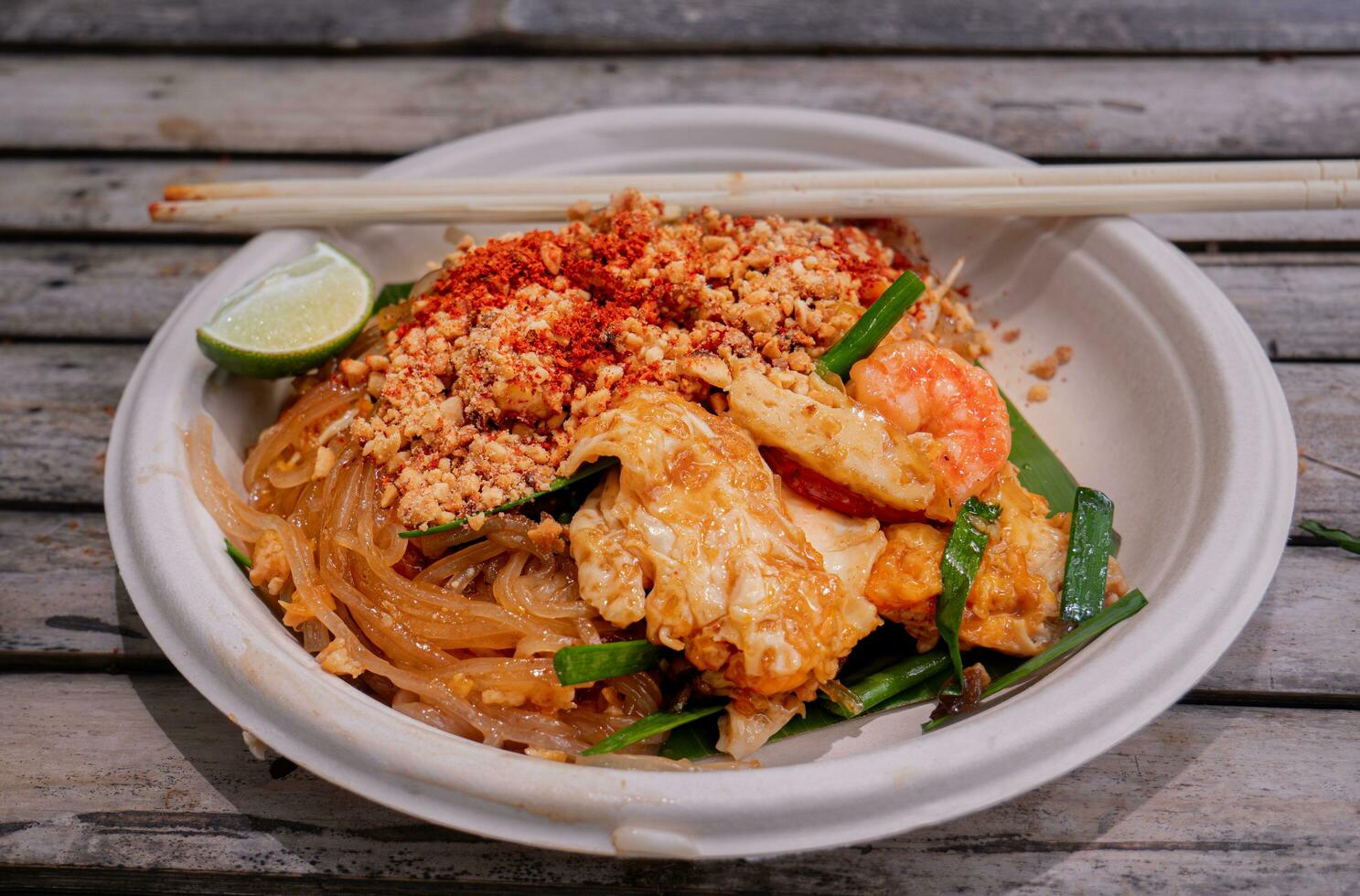 Pad Thai, fresh shrimp, is  popular food, famous in Thailand. It is a type of noodles, stir-fried dry, add meat or seafood, squid with ground peanuts, seasoned with sugar, fish sauce, and chili powder photo