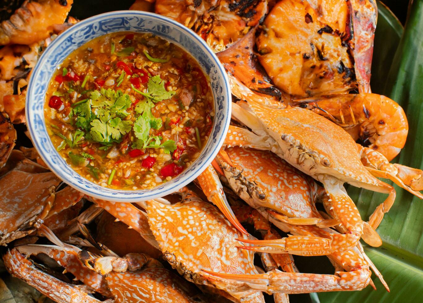 Seafood dishes such as grilled shrimp and crab and seafood sauce It consists of fresh chili, lime juice, ginger, garlic, sugar and fish sauce. A popular seafood set in Thailand. photo