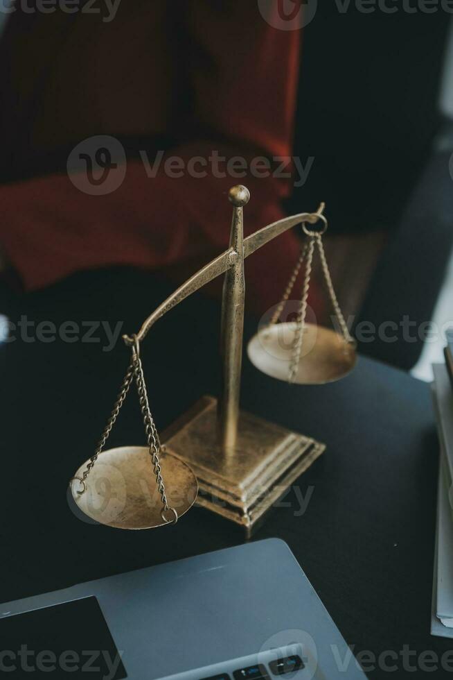 Justice and law concept.Male judge in a courtroom with the gavel, working with, computer and docking keyboard, eyeglasses, on table in morning light photo