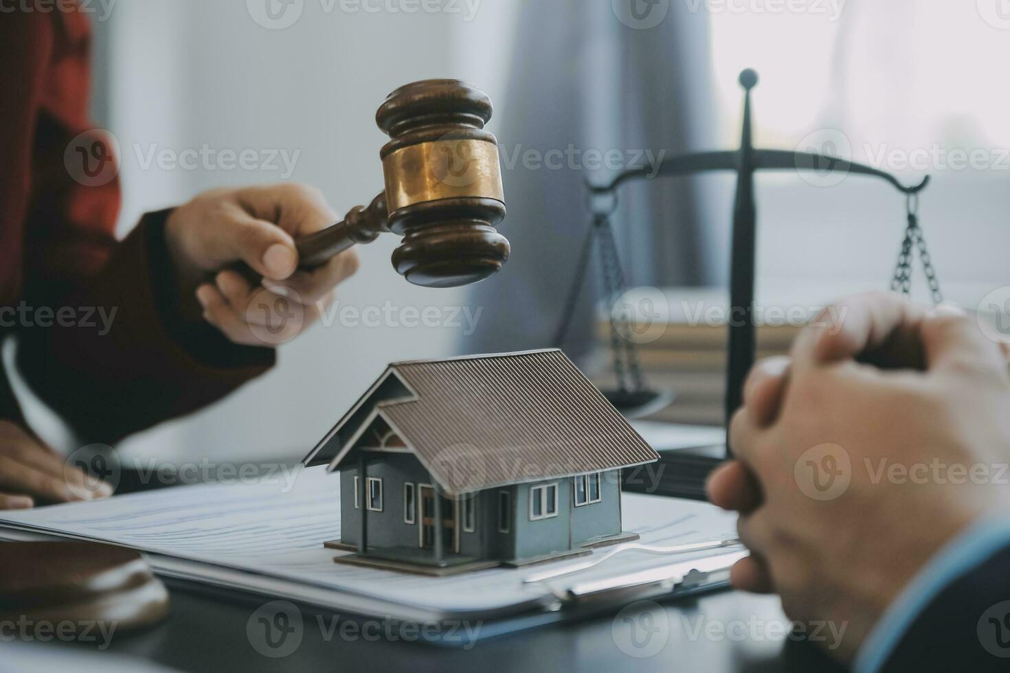 Justice and law concept.Male judge in a courtroom with the gavel, working with, computer and docking keyboard, eyeglasses, on table in morning light photo