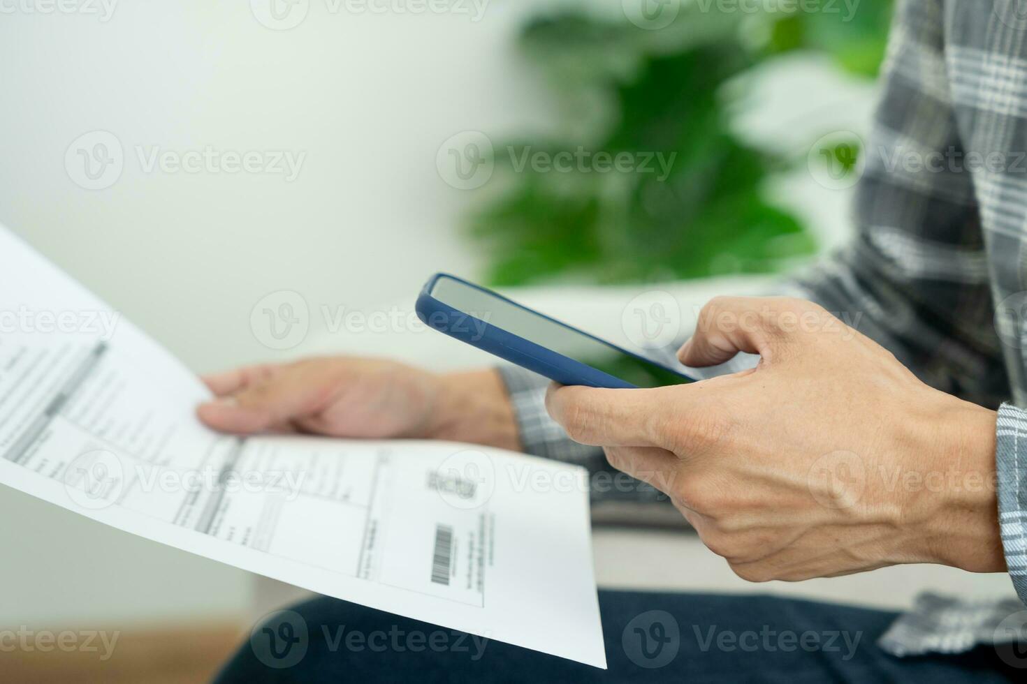 business man use phone to scan barcode or QR codes to pay credit card bill after receiving document invoice online. payment, receive, paying electricity, digital payments without money, technology photo