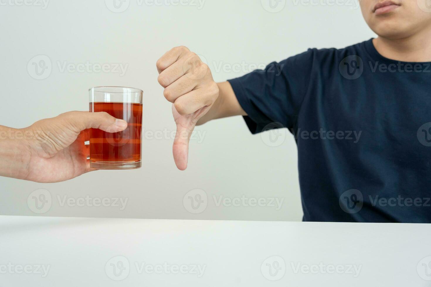 man refuses say no and avoid to drink an alcohol whiskey , stopping hand sign male, alcoholism treatment, alcohol addiction, quit booze, Stop Drinking Alcohol. Refuse Glass liquor, unhealthy, reject photo