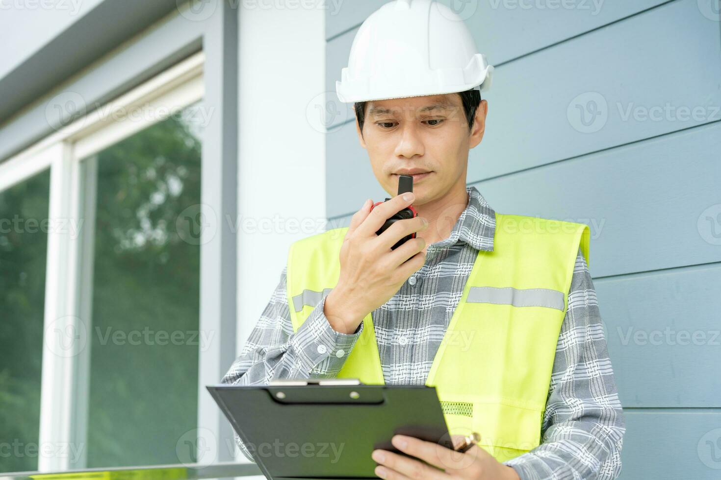 inspector or engineer is inspecting construction and quality assurance new house using a checklist. Engineers or architects or contactor work to build the house before handing it over to the homeowner photo