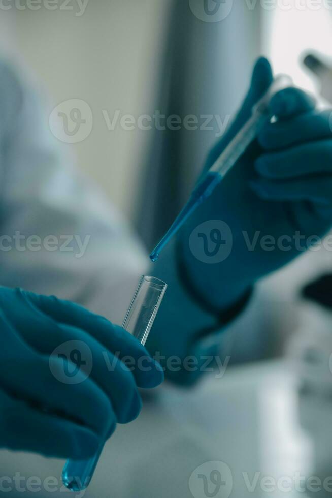 biochemical research scientist team working with microscope for coronavirus vaccine development in pharmaceutical research labolatory, selective focus photo