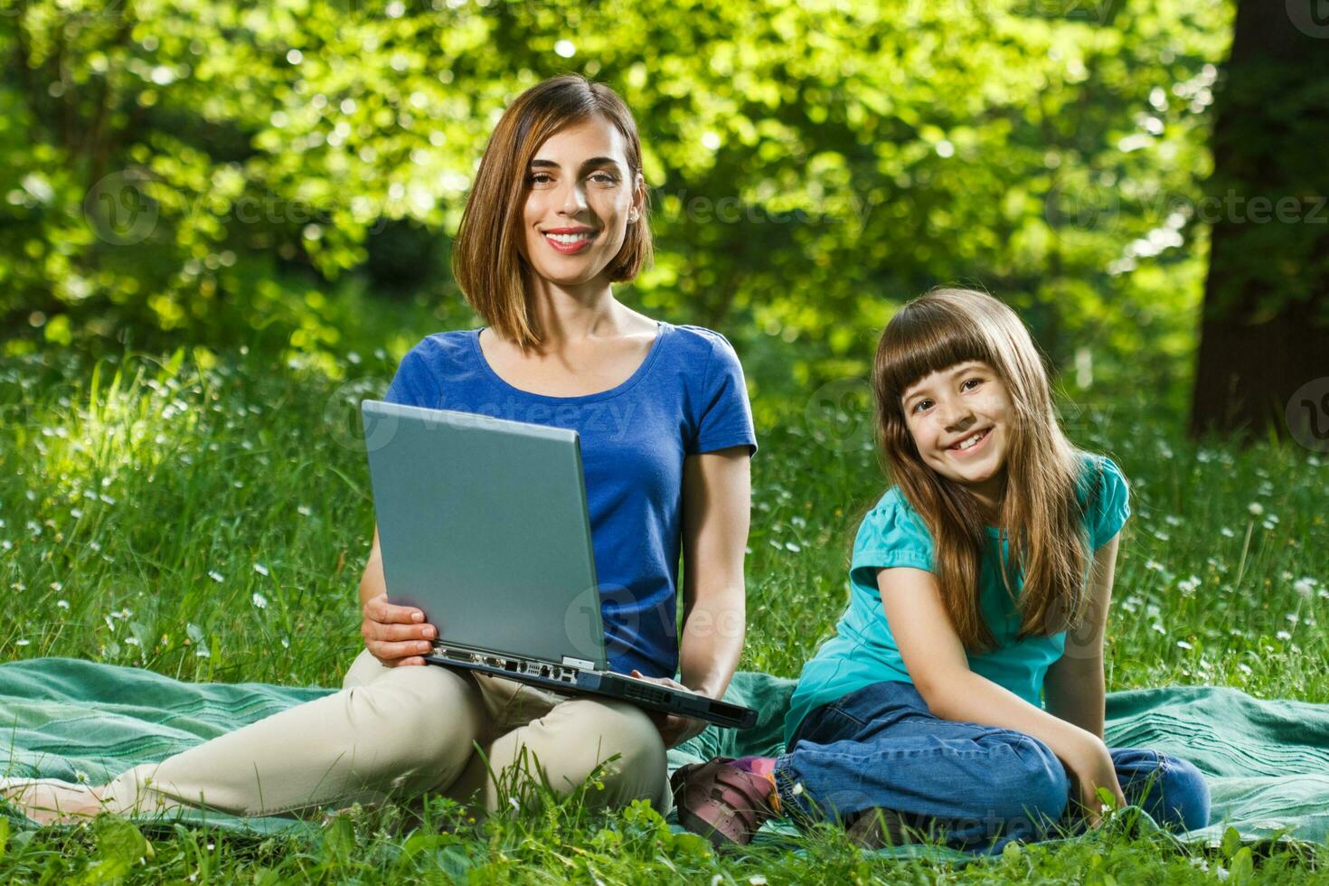 Mother and daughter using laptop photo