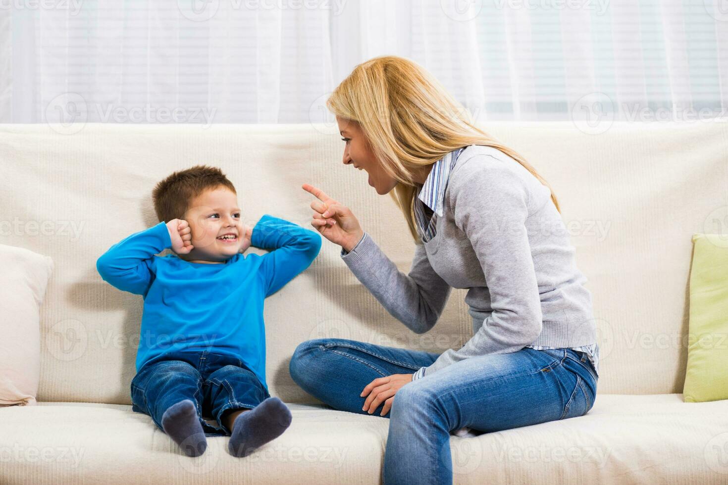 Angry mother is scolding at her son. photo