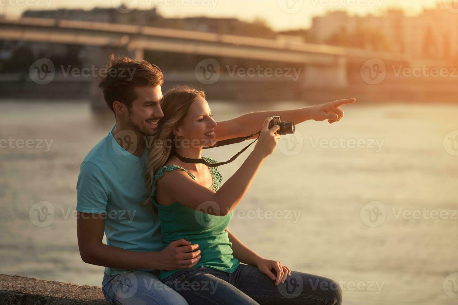 Young happy couple photographing together. photo