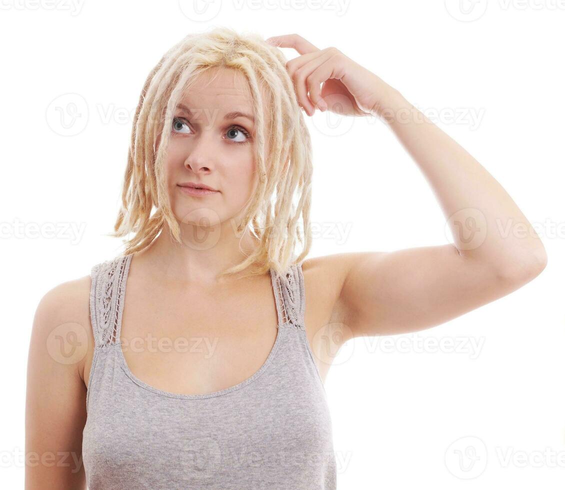 pensive young woman with blonde dreadlocks photo