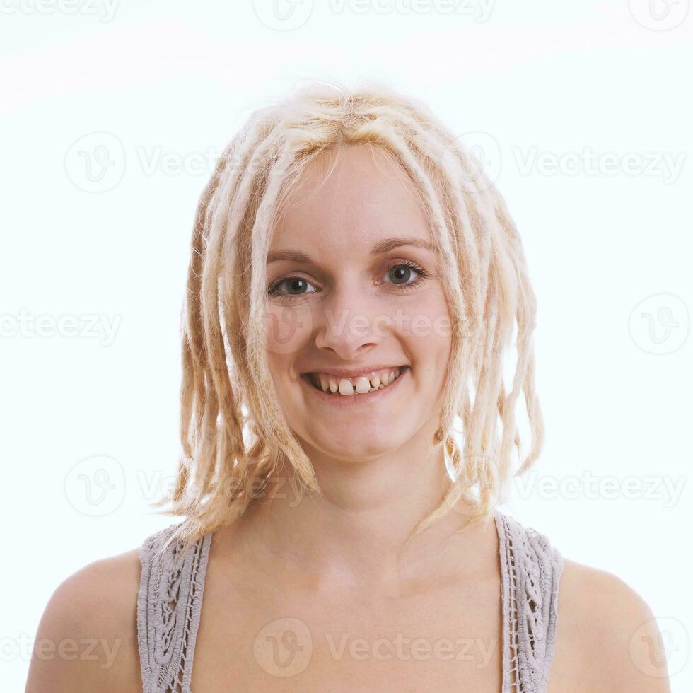 happy young woman with blond dreadlocks and tooth gap photo